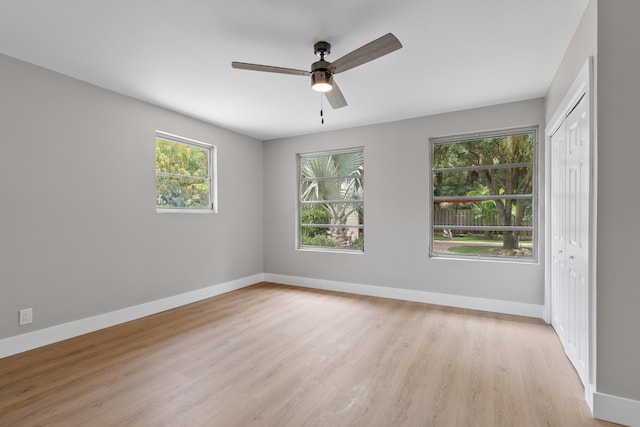 709 SW Bryant Ave, Stuart, FL 34994 - unfurnished bedroom with light wood finished floors, a closet, baseboards, and a ceiling fan