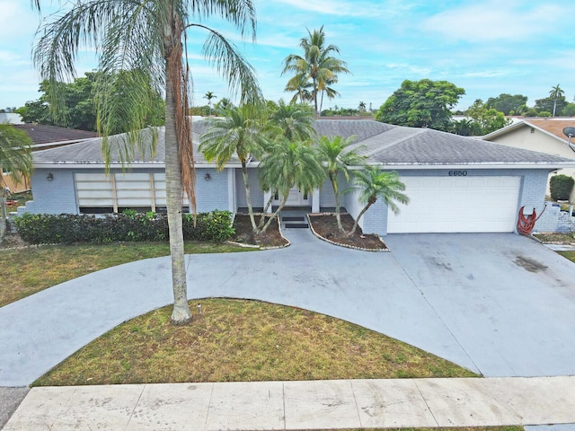 6650 NW 22nd Ct, Margate, FL 33063 - view of front of property featuring a garage, driveway, a front lawn, and brick siding