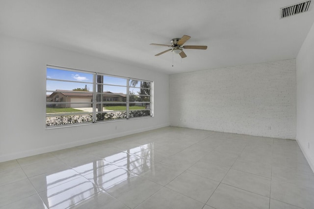 6650 NW 22nd Ct, Margate, FL 33063 - unfurnished room featuring brick wall, a ceiling fan, tile patterned flooring, and baseboards