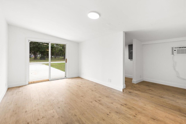 7802 Miramar Ave, Fort Pierce, FL 34951 - spare room with lofted ceiling, wood finished floors, electric panel, baseboards, and a wall mounted AC