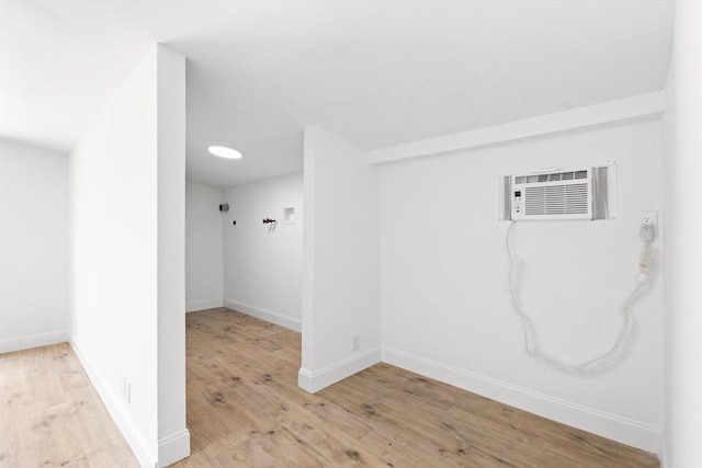 7802 Miramar Ave, Fort Pierce, FL 34951 - empty room with wood finished floors, baseboards, and an AC wall unit
