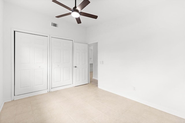 7802 Miramar Ave, Fort Pierce, FL 34951 - unfurnished bedroom featuring two closets, baseboards, and ceiling fan
