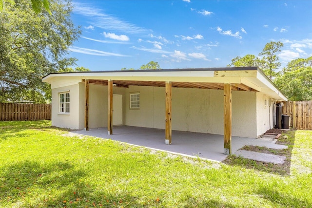 7802 Miramar Ave, Fort Pierce, FL 34951 - rear view of house featuring a patio, stucco siding, and a carport