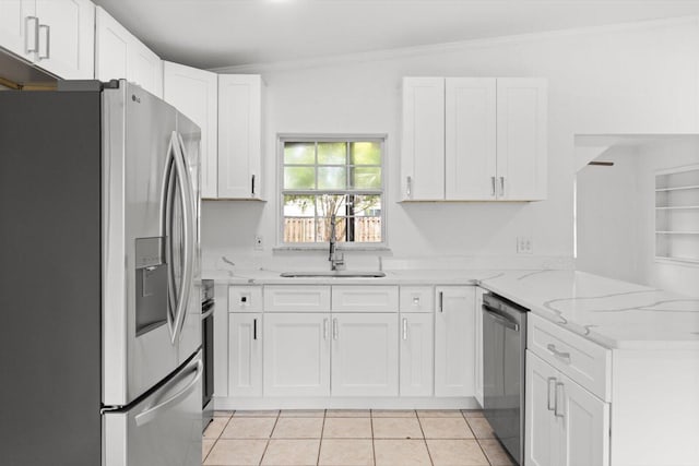 7802 Miramar Ave, Fort Pierce, FL 34951 - kitchen featuring stainless steel appliances, a peninsula, white cabinets, light stone counters, and light tile patterned floors