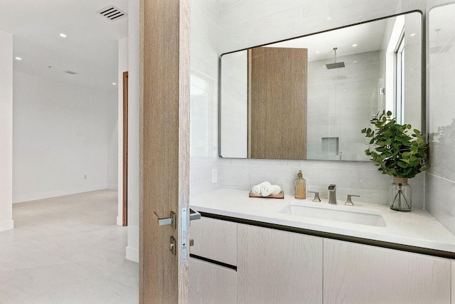 246 NE 6th Ave Unit Ph1, Delray Beach, FL 33483 - bathroom featuring vanity, a walk in shower, and tile patterned floors