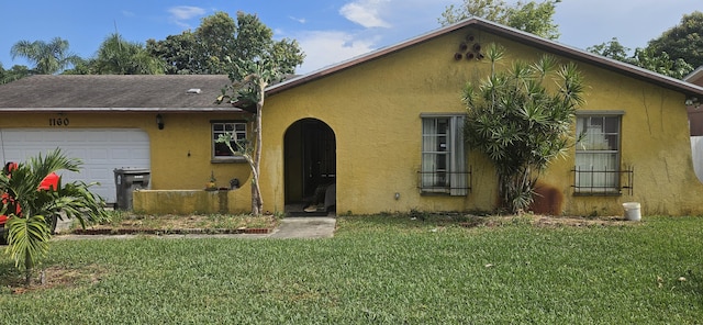 1160 Fernlea Dr, West Palm Beach, FL 33417 - view of front facade featuring stucco siding, a front yard, and a garage