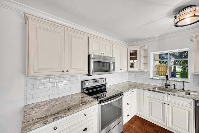 2934 SW 22nd Cir Unit 12A, Delray Beach, FL 33445 - kitchen with stainless steel appliances, light stone counters, backsplash, ornamental molding, and dark wood-style floors