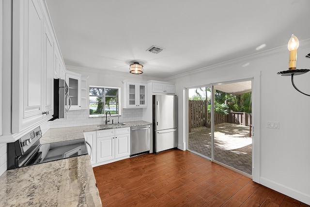 2934 SW 22nd Cir Unit 12A, Delray Beach, FL 33445 - kitchen featuring stainless steel appliances, light stone countertops, decorative backsplash, dark wood-type flooring, and white cabinets