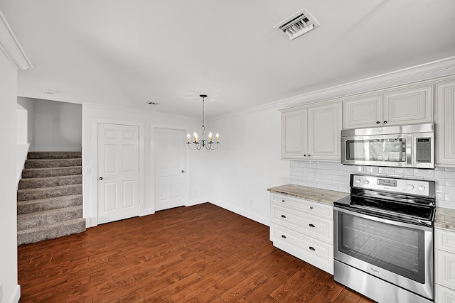 2934 SW 22nd Cir Unit 12A, Delray Beach, FL 33445 - kitchen with stainless steel appliances, a chandelier, decorative backsplash, dark wood-style floors, and light stone countertops