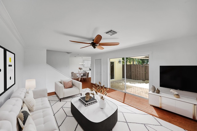 2934 SW 22nd Cir Unit 12A, Delray Beach, FL 33445 - living area with crown molding, wood finished floors, and ceiling fan