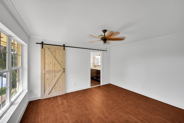 2934 SW 22nd Cir Unit 12A, Delray Beach, FL 33445 - unfurnished bedroom featuring multiple windows, crown molding, a barn door, wood finished floors, and ceiling fan