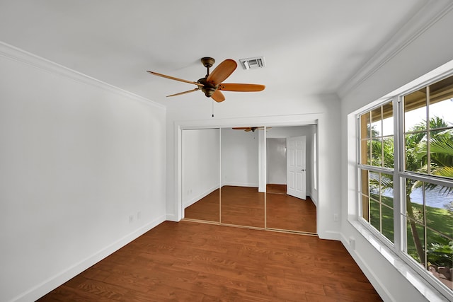 2934 SW 22nd Cir Unit 12A, Delray Beach, FL 33445 - unfurnished bedroom featuring ornamental molding, dark wood-style flooring, a ceiling fan, and a closet
