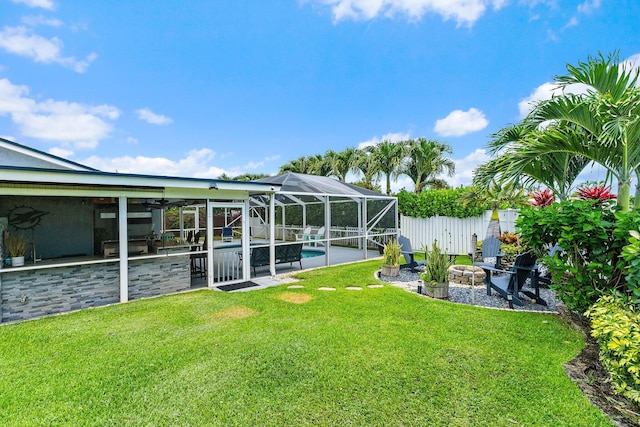 9674 Dogwood Ave, Palm Beach Gardens, FL 33410 - view of yard featuring a patio area, an outdoor fire pit, a lanai, and a ceiling fan