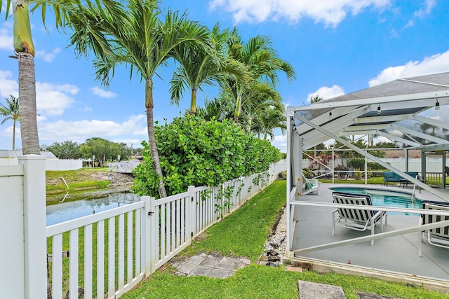 9674 Dogwood Ave, Palm Beach Gardens, FL 33410 - fenced backyard with a water view, a patio area, and a lanai