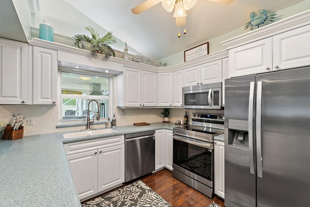9674 Dogwood Ave, Palm Beach Gardens, FL 33410 - kitchen featuring appliances with stainless steel finishes, a sink, lofted ceiling, tasteful backsplash, and white cabinetry