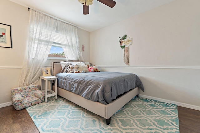 9674 Dogwood Ave, Palm Beach Gardens, FL 33410 - bedroom with baseboards, wood finished floors, and a ceiling fan