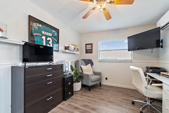 9674 Dogwood Ave, Palm Beach Gardens, FL 33410 - home office with light wood-style flooring, ceiling fan, and a wainscoted wall