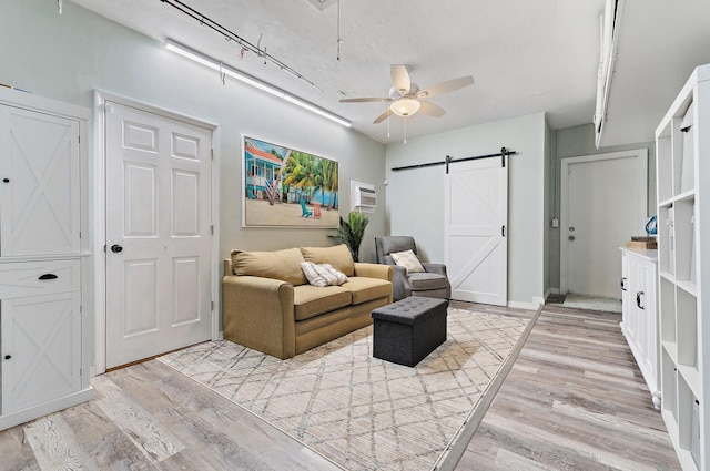9674 Dogwood Ave, Palm Beach Gardens, FL 33410 - living room with a barn door, light wood-type flooring, a ceiling fan, and attic access