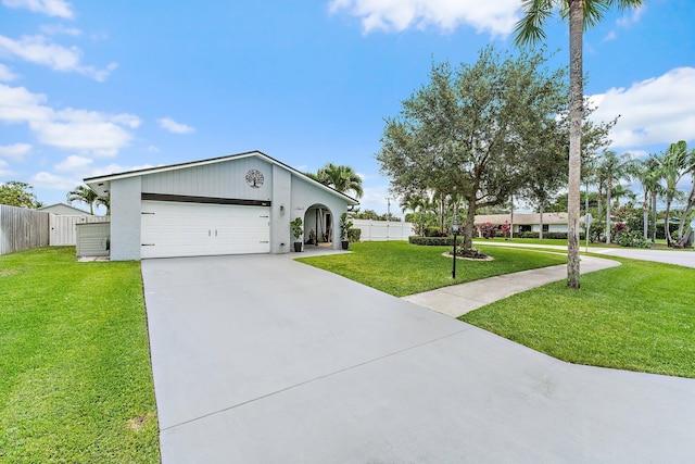 9674 Dogwood Ave, Palm Beach Gardens, FL 33410 - ranch-style house with driveway and an attached garage