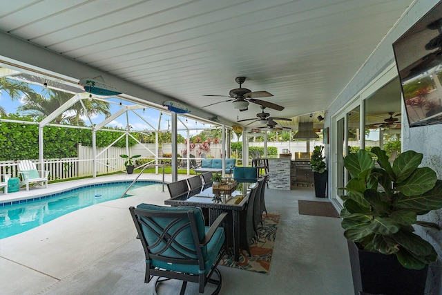 9674 Dogwood Ave, Palm Beach Gardens, FL 33410 - fenced backyard featuring an outdoor kitchen, a patio, ceiling fan, and glass enclosure
