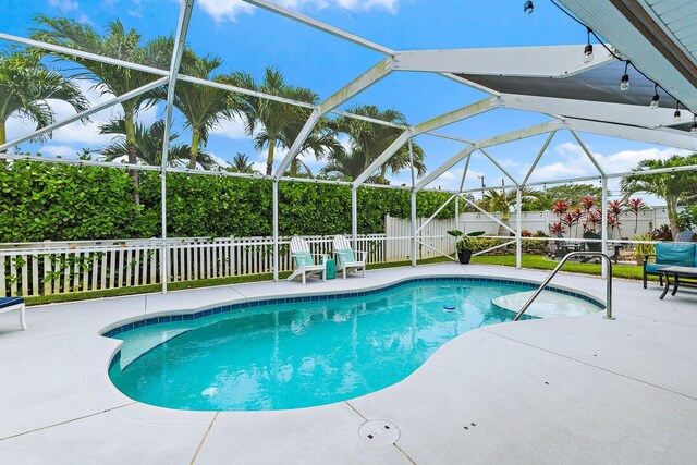 9674 Dogwood Ave, Palm Beach Gardens, FL 33410 - view of pool with a fenced backyard, a patio, and glass enclosure