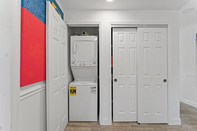 1509 N N St, Lake Worth Beach, FL 33460 - washroom featuring stacked washer / dryer and light wood finished floors