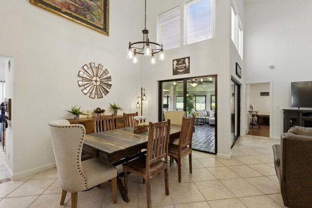 5625 Lakeview Mews Ct, Boynton Beach, FL 33437 - dining room with a chandelier, a towering ceiling, light tile patterned flooring, and baseboards