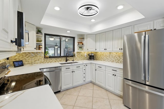 5625 Lakeview Mews Ct, Boynton Beach, FL 33437 - kitchen featuring appliances with stainless steel finishes, open shelves, a tray ceiling, a sink, and tasteful backsplash
