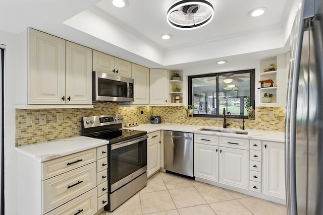 5625 Lakeview Mews Ct, Boynton Beach, FL 33437 - kitchen featuring stainless steel appliances, open shelves, a sink, a raised ceiling, and recessed lighting