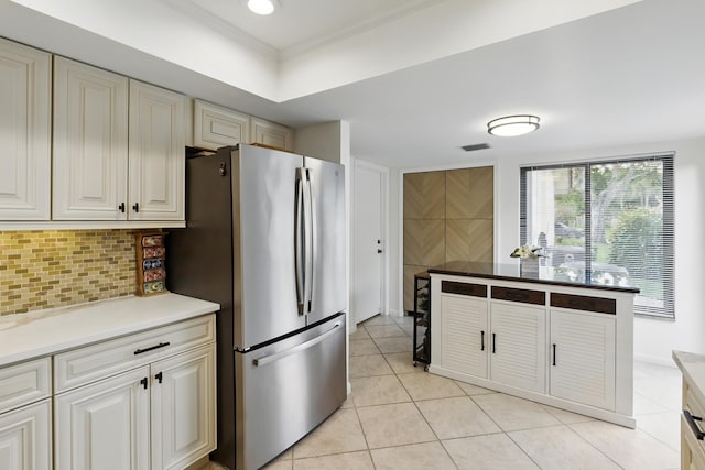 5625 Lakeview Mews Ct, Boynton Beach, FL 33437 - kitchen with freestanding refrigerator, backsplash, light tile patterned floors, ornamental molding, and light countertops