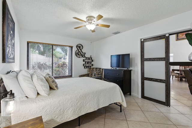 5625 Lakeview Mews Ct, Boynton Beach, FL 33437 - bedroom featuring light tile patterned floors, a textured ceiling, and ceiling fan