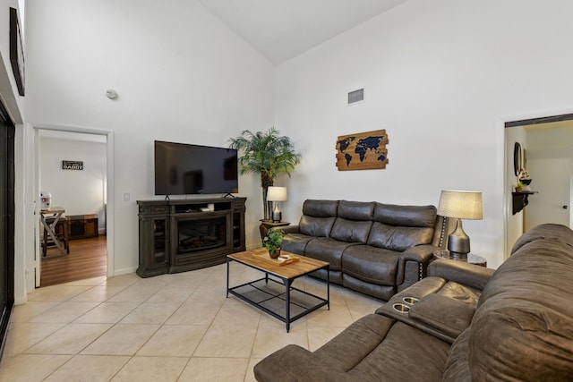 5625 Lakeview Mews Ct, Boynton Beach, FL 33437 - living area with high vaulted ceiling, light tile patterned floors, a fireplace, and baseboards