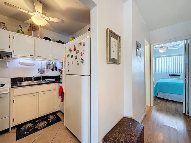 301 E Mcnab Rd Unit 214, Pompano Beach, FL 33060 - kitchen featuring white appliances, a sink, ceiling fan, white cabinets, and dark countertops