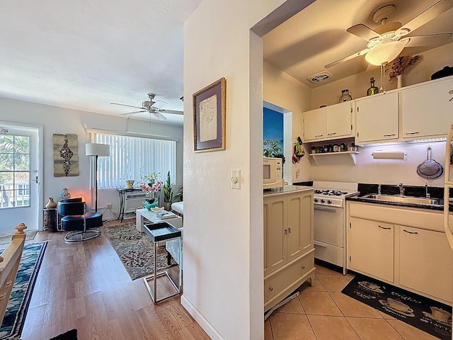 301 E Mcnab Rd Unit 214, Pompano Beach, FL 33060 - kitchen featuring ceiling fan, white appliances, dark countertops, a sink, and open floor plan