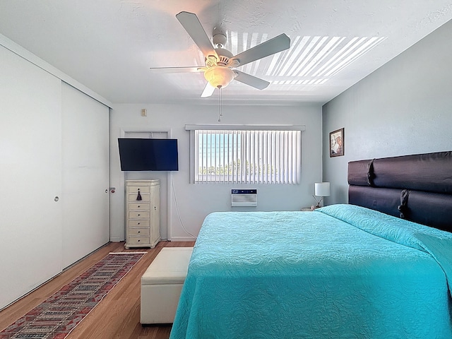 301 E Mcnab Rd Unit 214, Pompano Beach, FL 33060 - bedroom with wood finished floors, ceiling fan, a closet, and a wall mounted AC