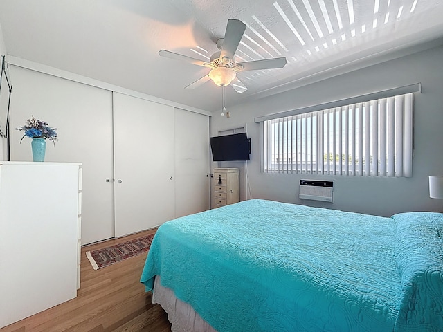 301 E Mcnab Rd Unit 214, Pompano Beach, FL 33060 - bedroom with wood finished floors, a closet, a wall mounted AC, and ceiling fan