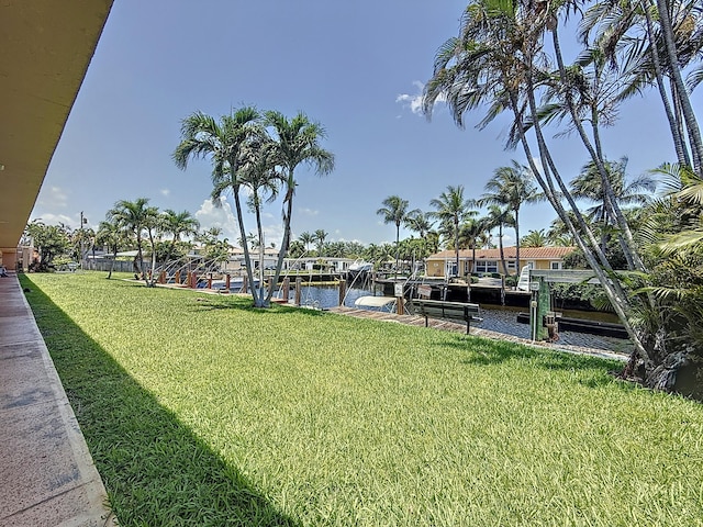 301 E Mcnab Rd Unit 214, Pompano Beach, FL 33060 - view of green lawn with a boat dock, a water view, and boat lift