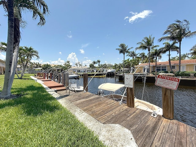 301 E Mcnab Rd Unit 214, Pompano Beach, FL 33060 - dock featuring a yard, a water view, and boat lift