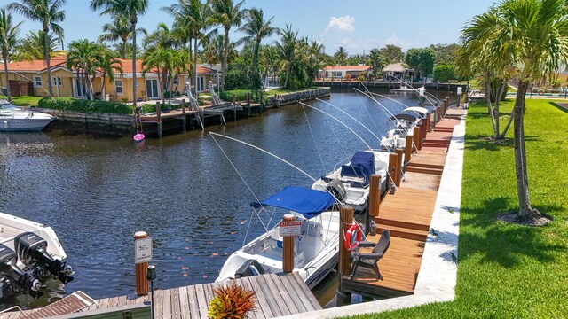 301 E Mcnab Rd Unit 214, Pompano Beach, FL 33060 - dock featuring a water view, a lawn, and boat lift
