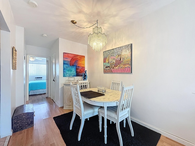 301 E Mcnab Rd Unit 214, Pompano Beach, FL 33060 - dining space featuring light wood-type flooring, a chandelier, and baseboards