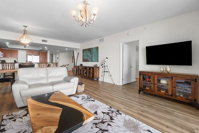 2640 Lake Shore Dr Unit 2409, Riviera Beach, FL 33404 - living area with light wood finished floors, a chandelier, and baseboards