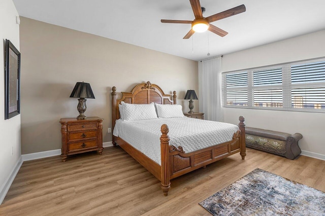 2640 Lake Shore Dr Unit 2409, Riviera Beach, FL 33404 - bedroom with light wood-style flooring, baseboards, and a ceiling fan