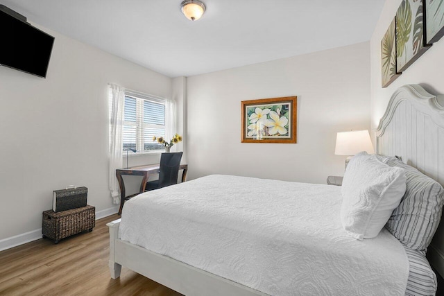 2640 Lake Shore Dr Unit 2409, Riviera Beach, FL 33404 - bedroom with light wood-type flooring and baseboards