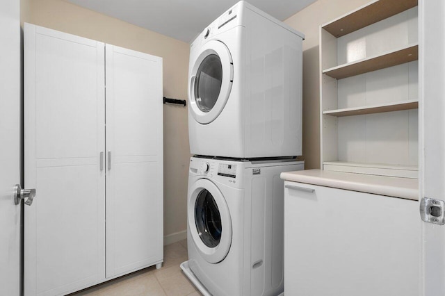 2640 Lake Shore Dr Unit 2409, Riviera Beach, FL 33404 - laundry room with cabinet space, stacked washing machine and dryer, and light tile patterned flooring