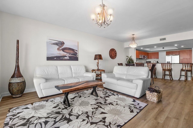2640 Lake Shore Dr Unit 2409, Riviera Beach, FL 33404 - living room with light wood-type flooring and a chandelier