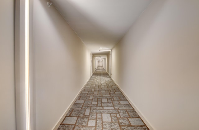 2667 N Ocean Blvd Unit I612, Boca Raton, FL 33431 - hall with baseboards and brick flooring