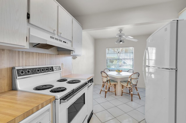 7 Stratford Dr Unit C, Boynton Beach, FL 33436 - kitchen featuring white appliances, under cabinet range hood, ceiling fan, light tile patterned floors, and light countertops