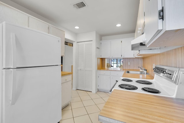 7 Stratford Dr Unit C, Boynton Beach, FL 33436 - kitchen with white appliances, a sink, light tile patterned flooring, white cabinets, and light countertops