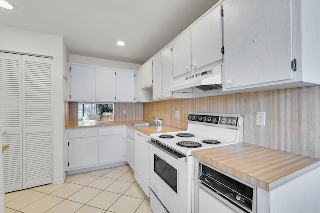 7 Stratford Dr Unit C, Boynton Beach, FL 33436 - kitchen with white appliances, under cabinet range hood, a sink, light countertops, and light tile patterned flooring