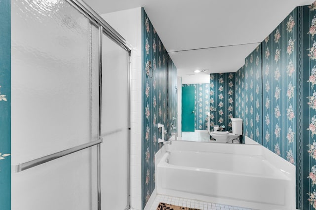7 Stratford Dr Unit C, Boynton Beach, FL 33436 - bathroom with wallpapered walls, a shower stall, a garden tub, toilet, and tile patterned floors